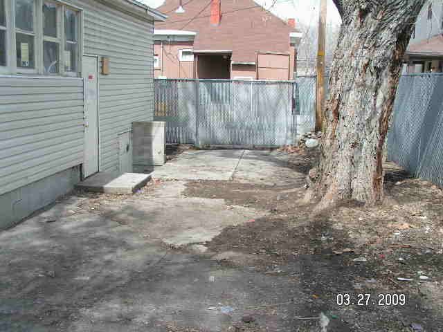 The back of a house with a concrete patio.